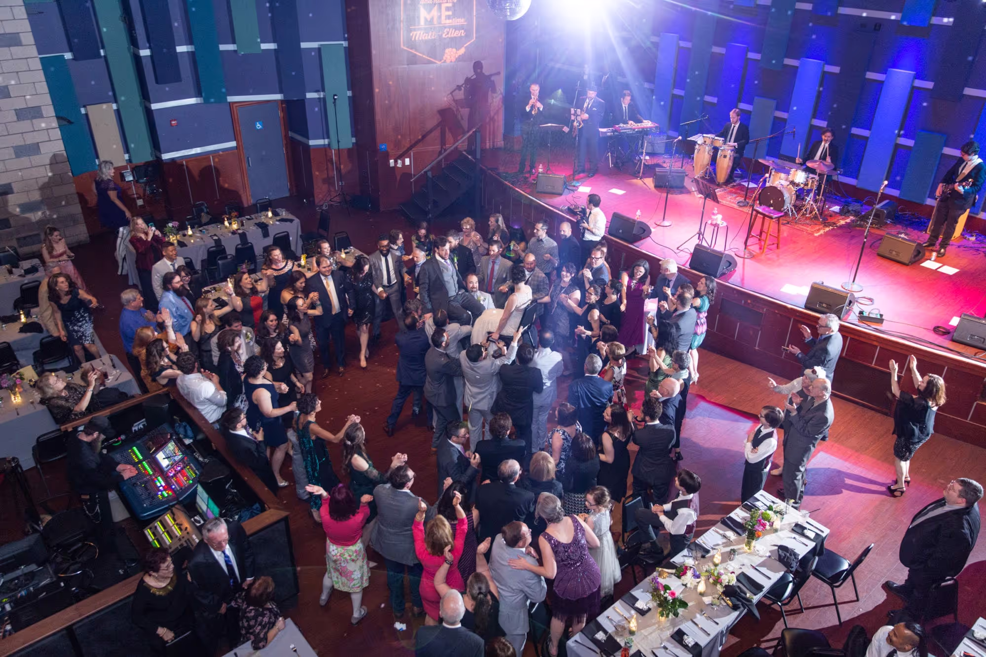 A large group of people standing around a room